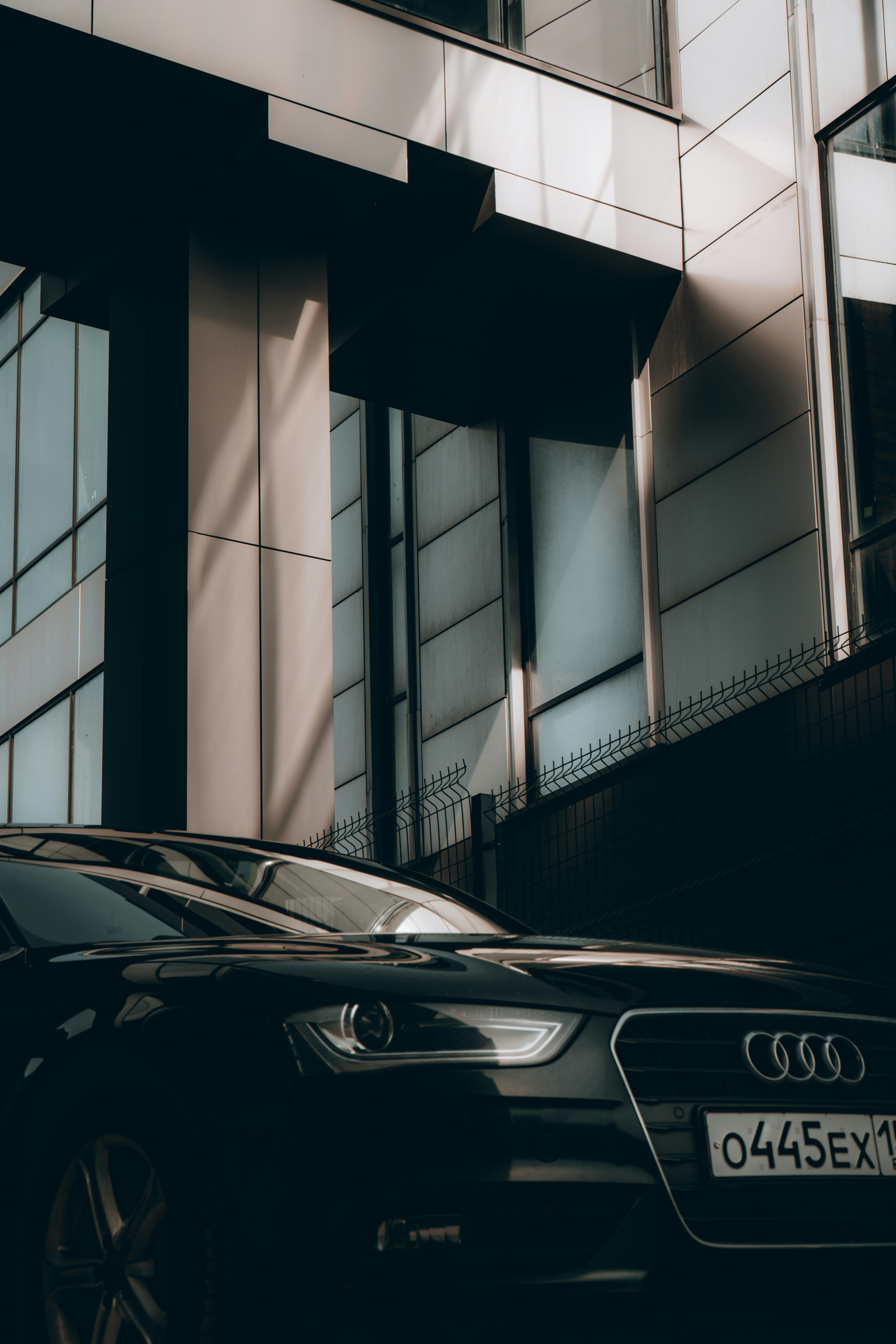 black car parked beside building